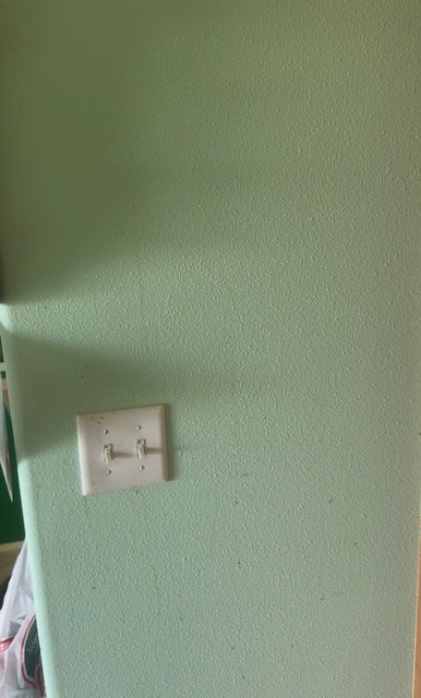After cleaning: refreshed wall and light-switch area
